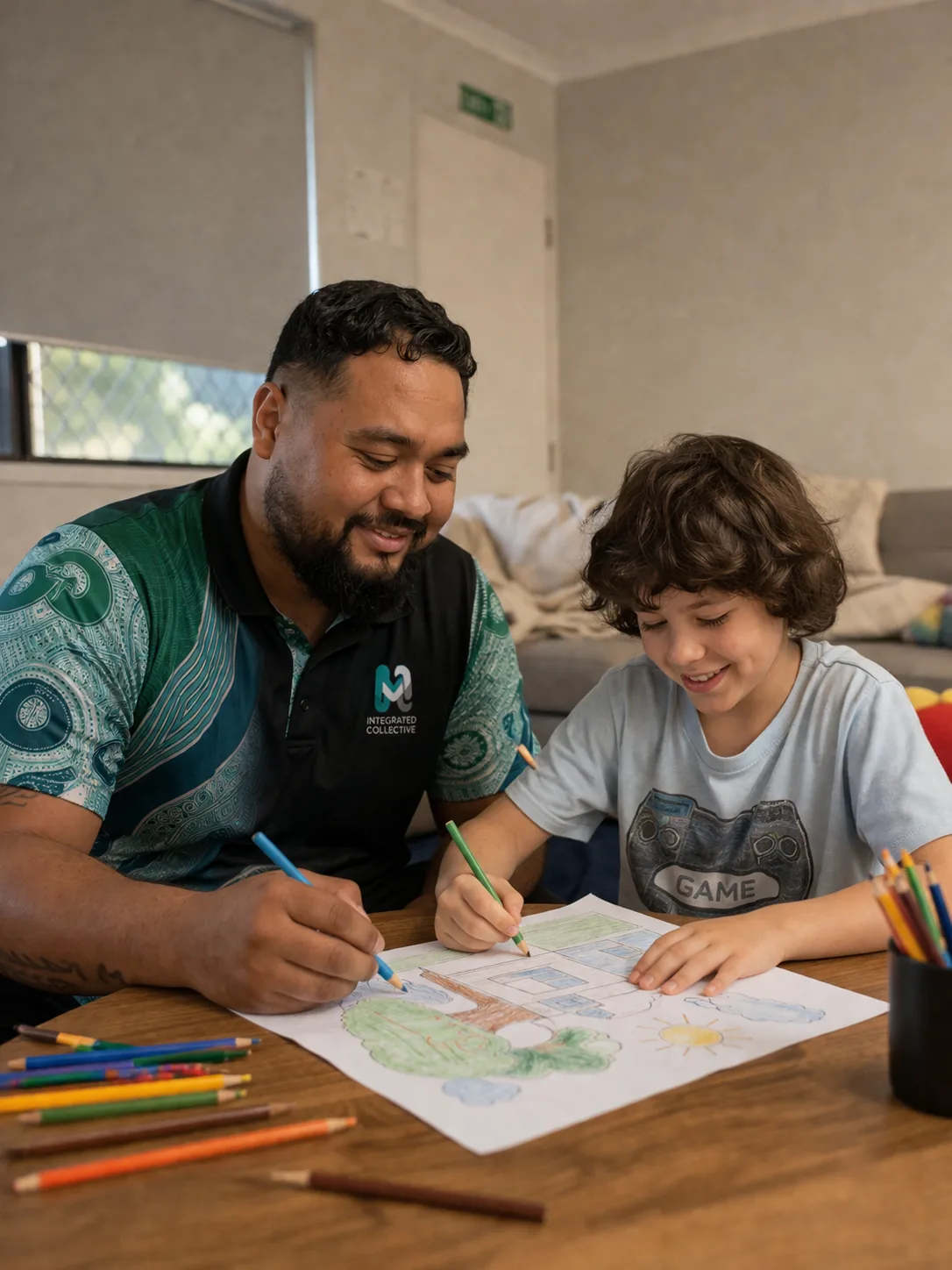 Integrated Collective worker drawing alongside a young person at home